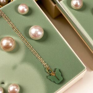 Gold-toned necklace with a green butterfly pendant